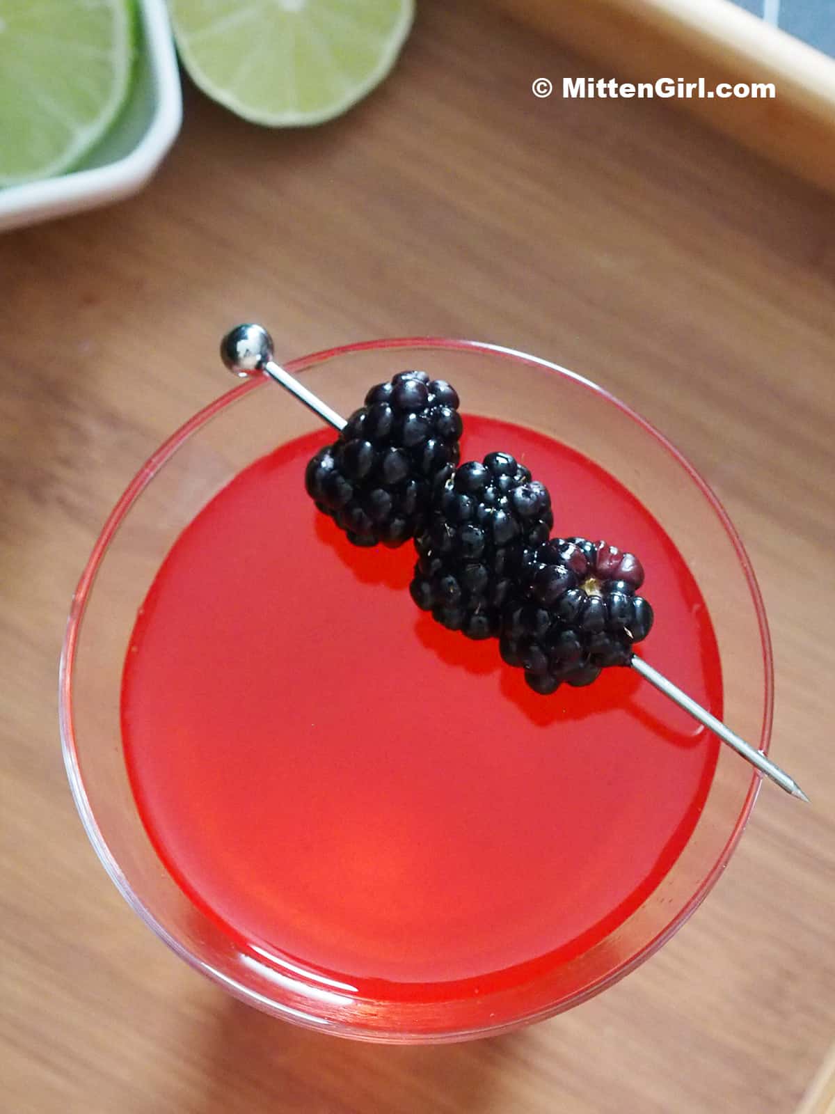 A blackberry martini garnished with fresh berries. 
