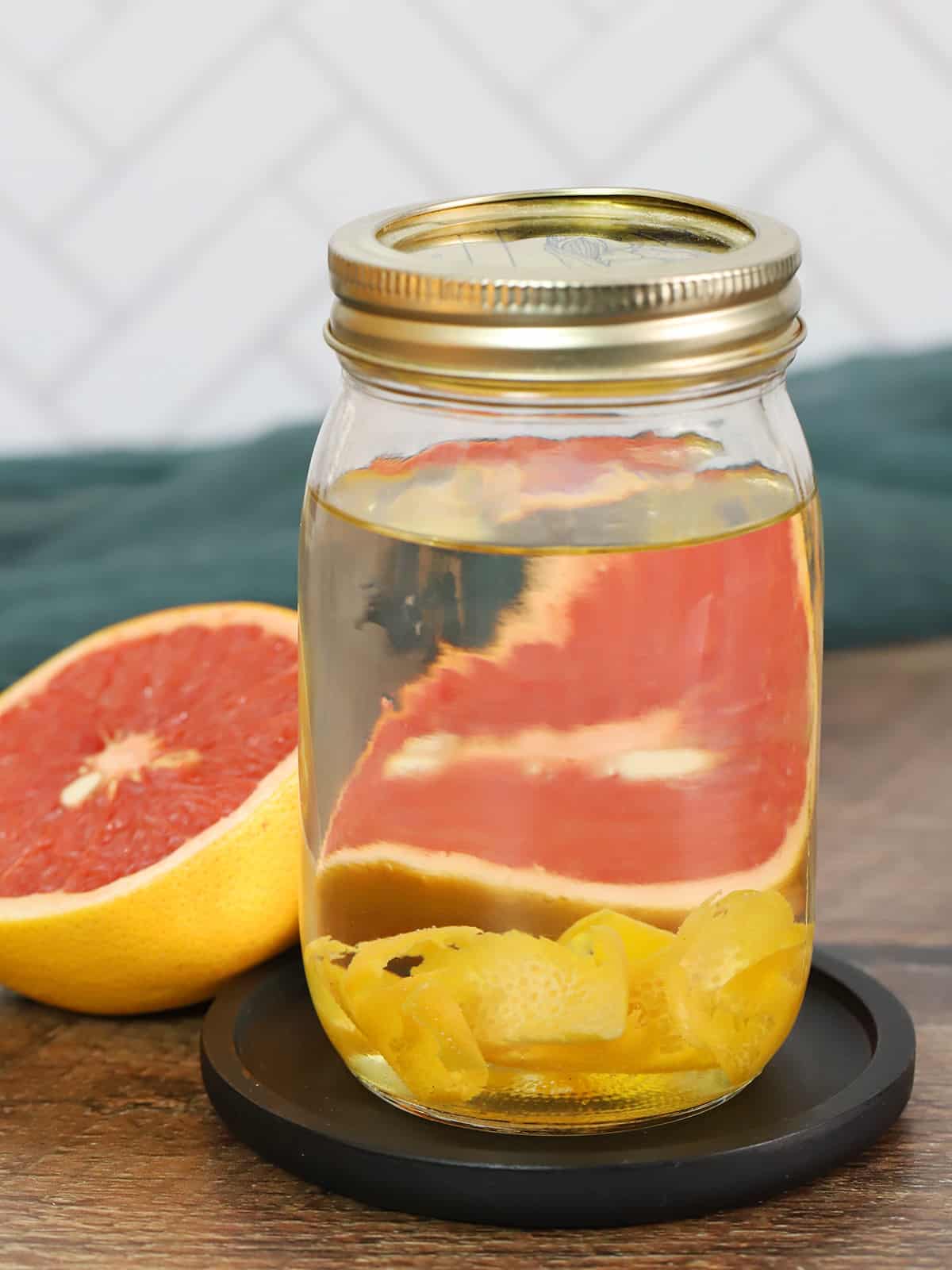 A jar of grapefruit infused tequila. 