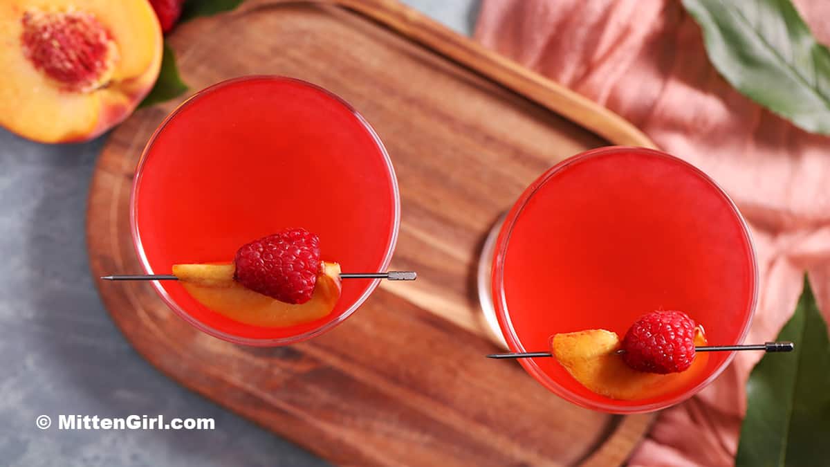 A pair of raspberry peach martinis.