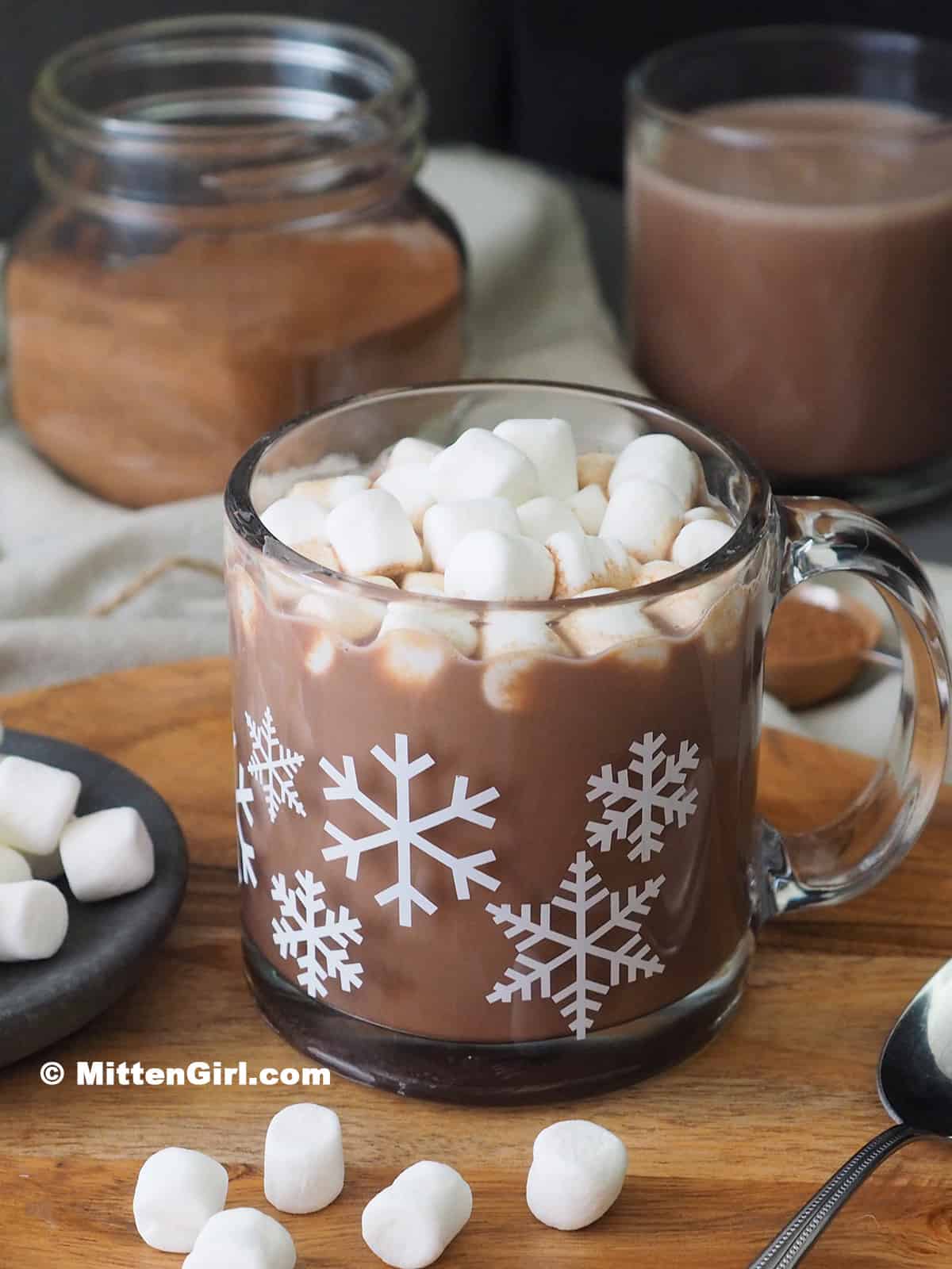 A mug of hot chocolate topped with lots of mini marshmallows.