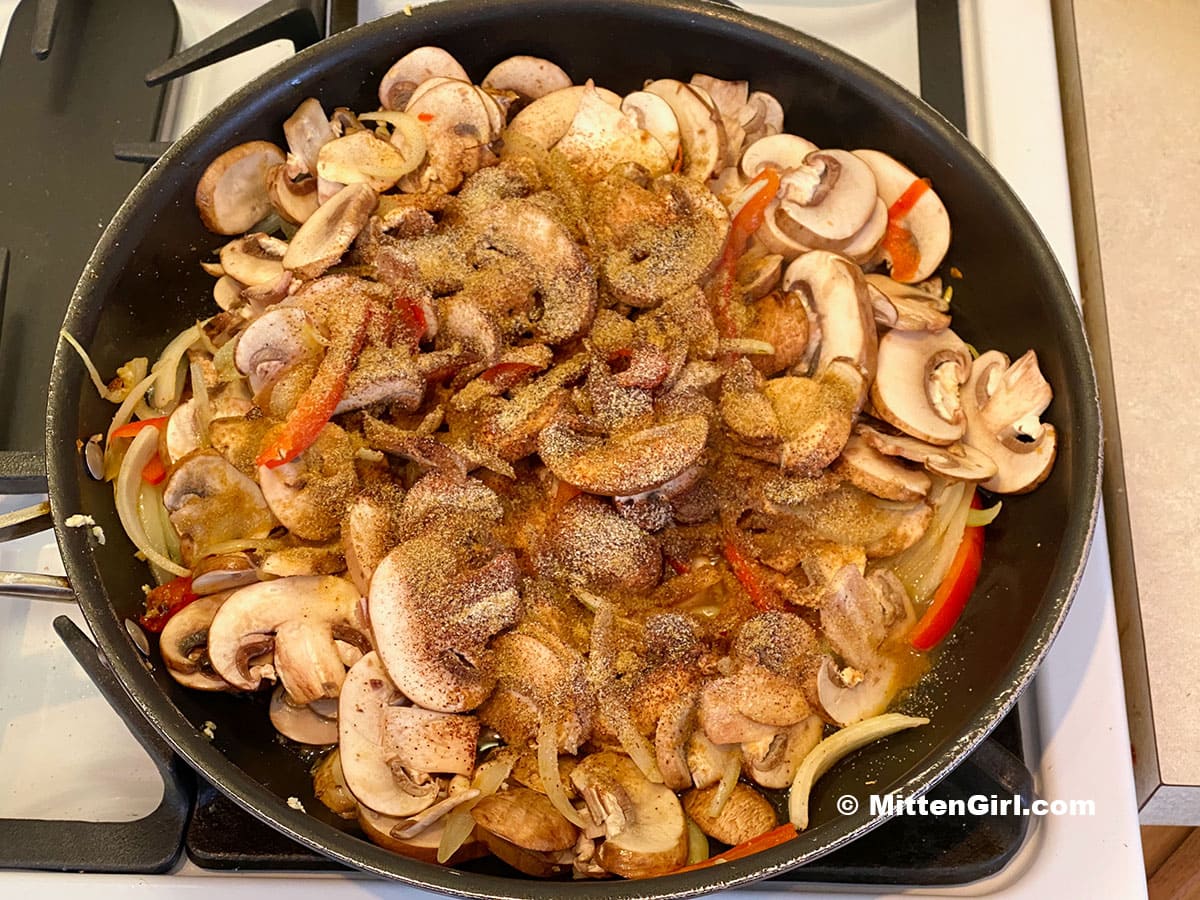 Sliced vegetables with spices in a skillet