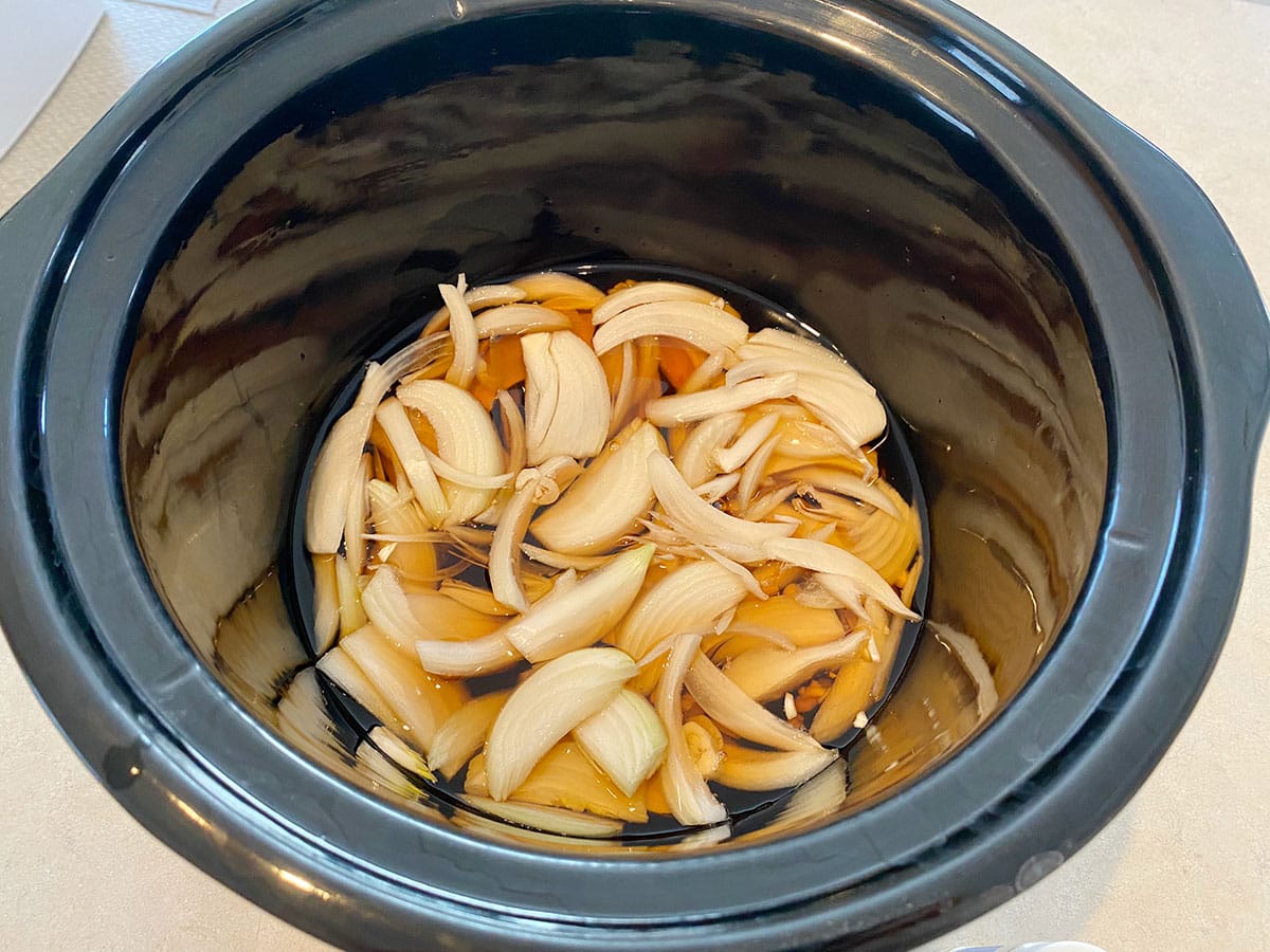 Onion, garlic and broth in the slow cooker