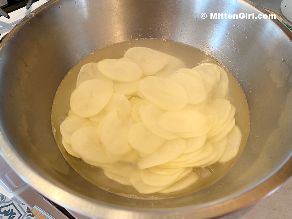Potatoes sliced, in water