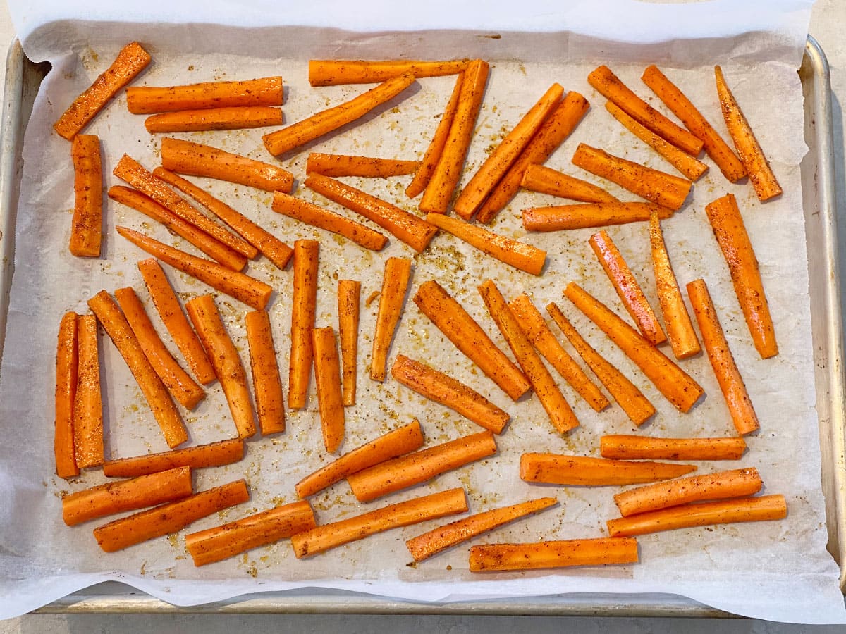 Carrots spread out on a baking tray