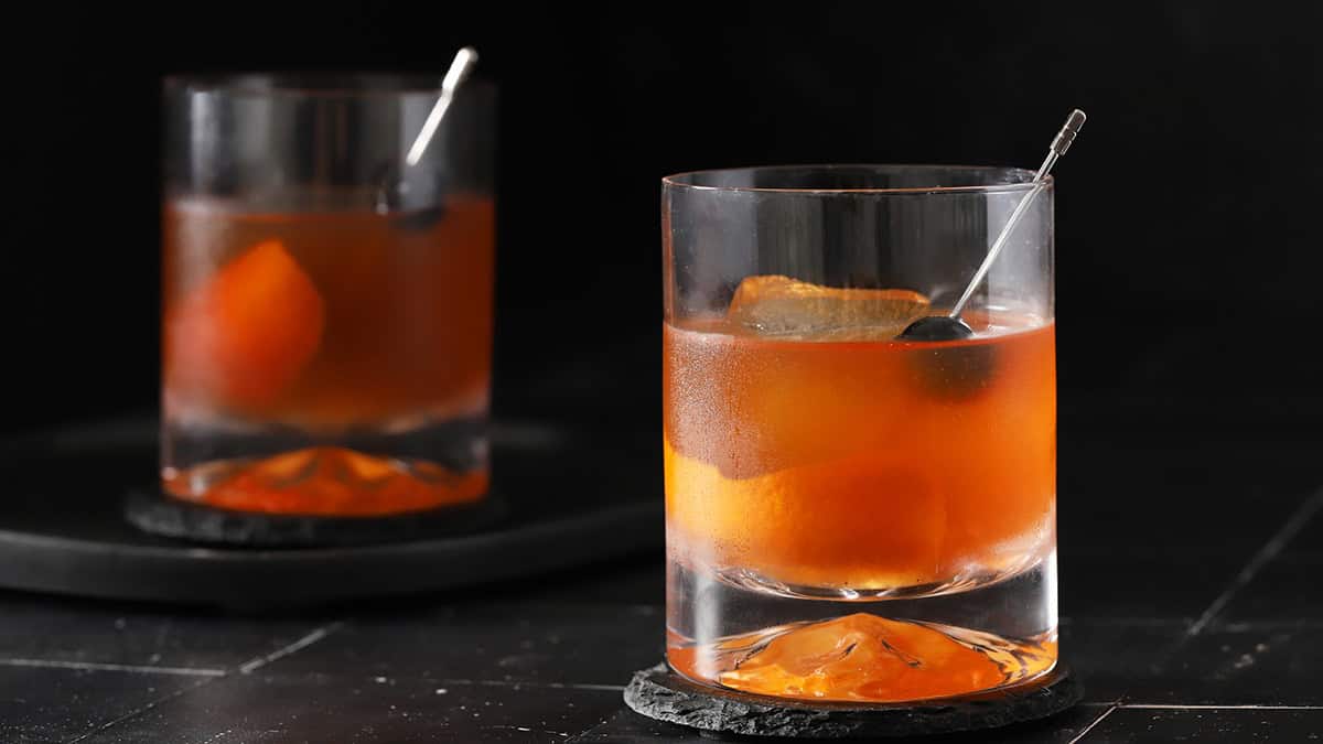 A pair of Old Fashioned cocktails.