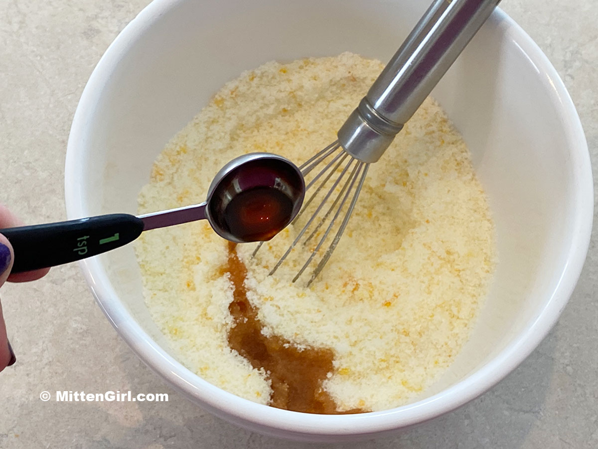 Adding vanilla to sugar and orange zest
