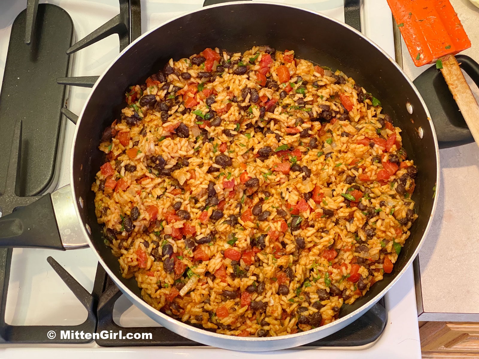 Tomato rice and beans in the skillet, all stirred together.