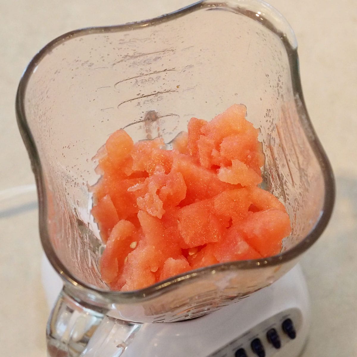 Chunks of watermelon in a blender. 
