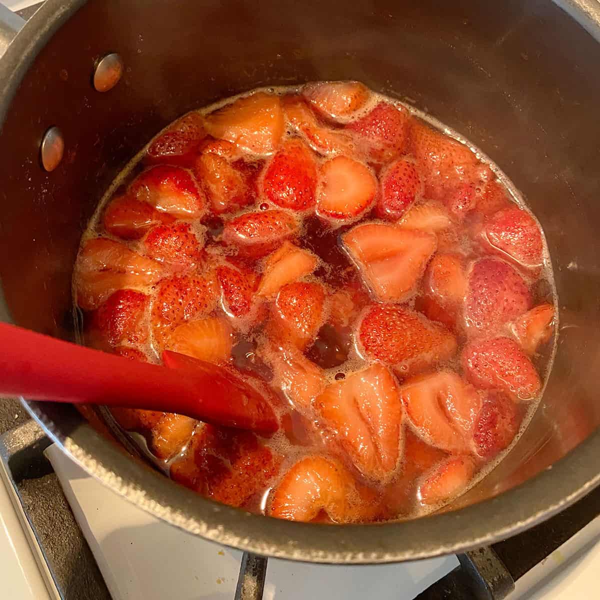 Strawberries in a pot with sweetener and water