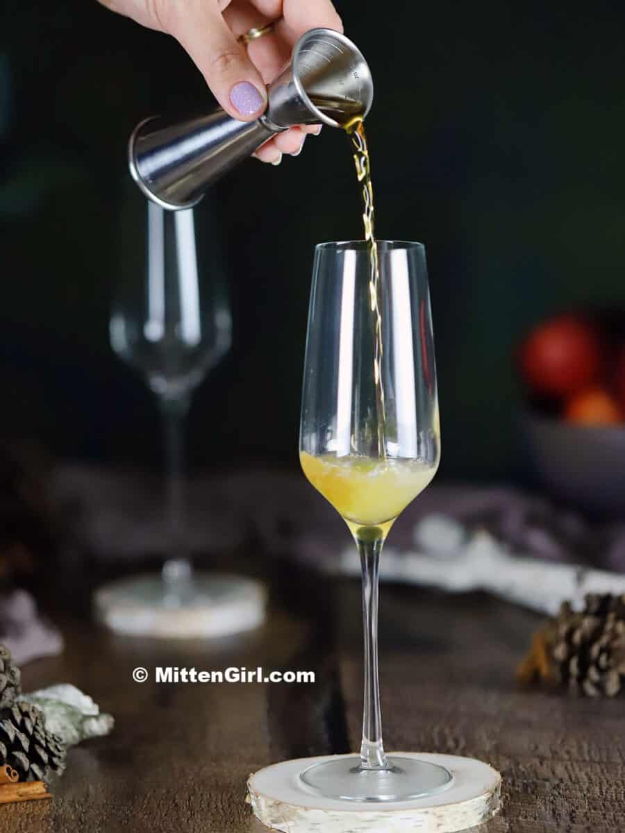 Pouring brown sugar syrup into a champagne flute
