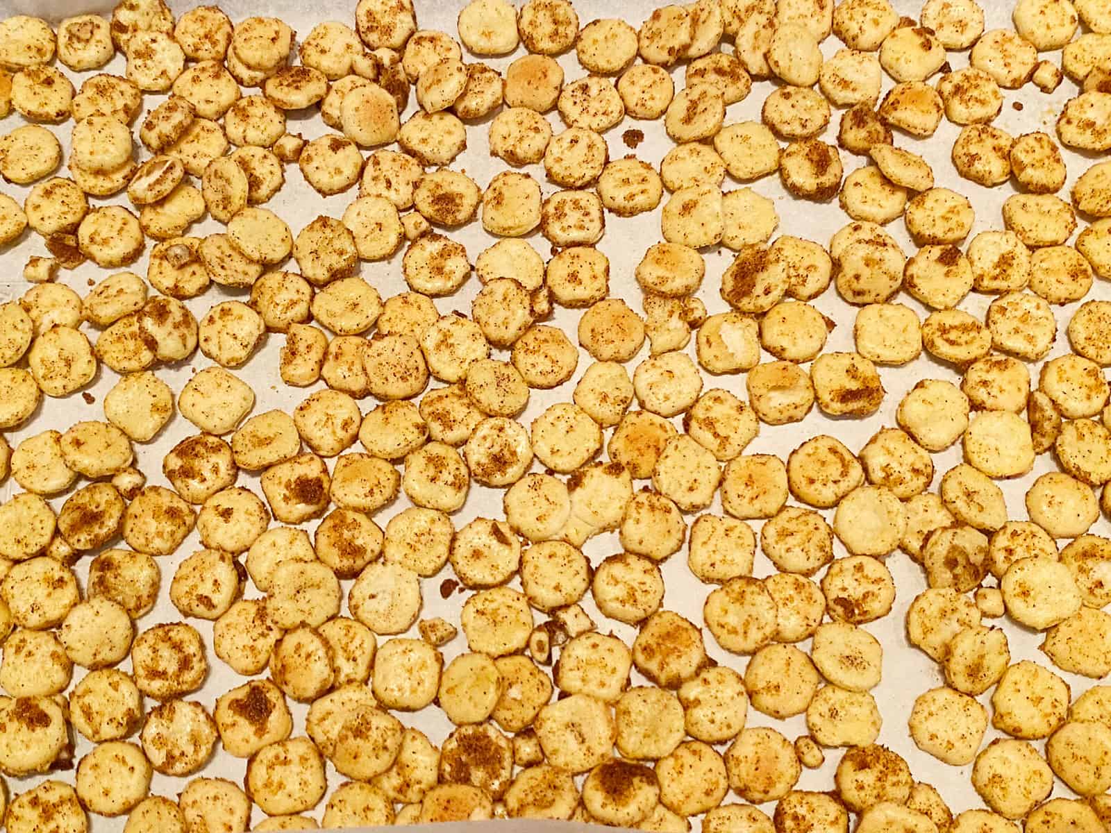BBQ spice-coated crackers on a sheet pan