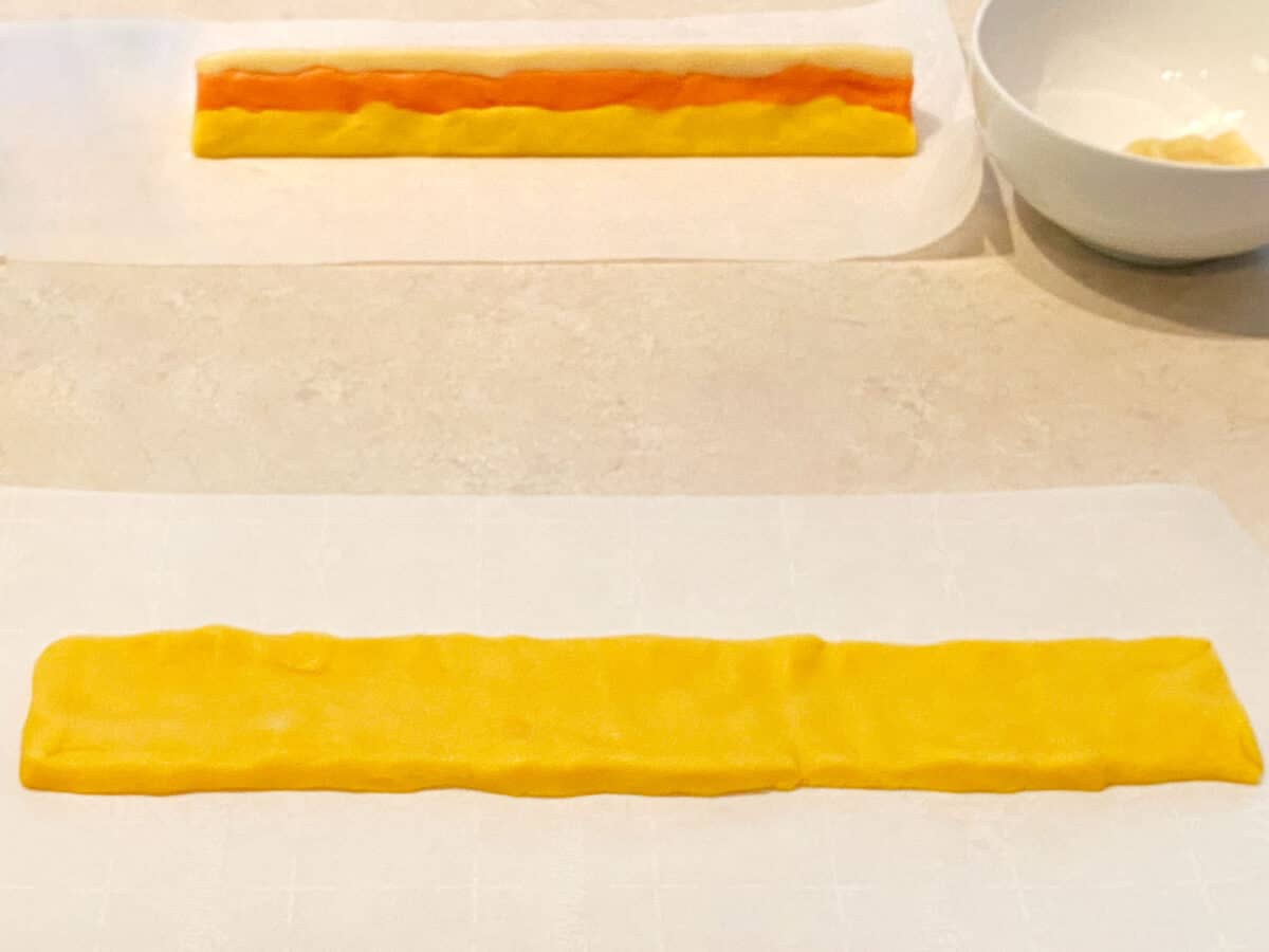 Yellow dough flattened out into a long, skinny rectangle