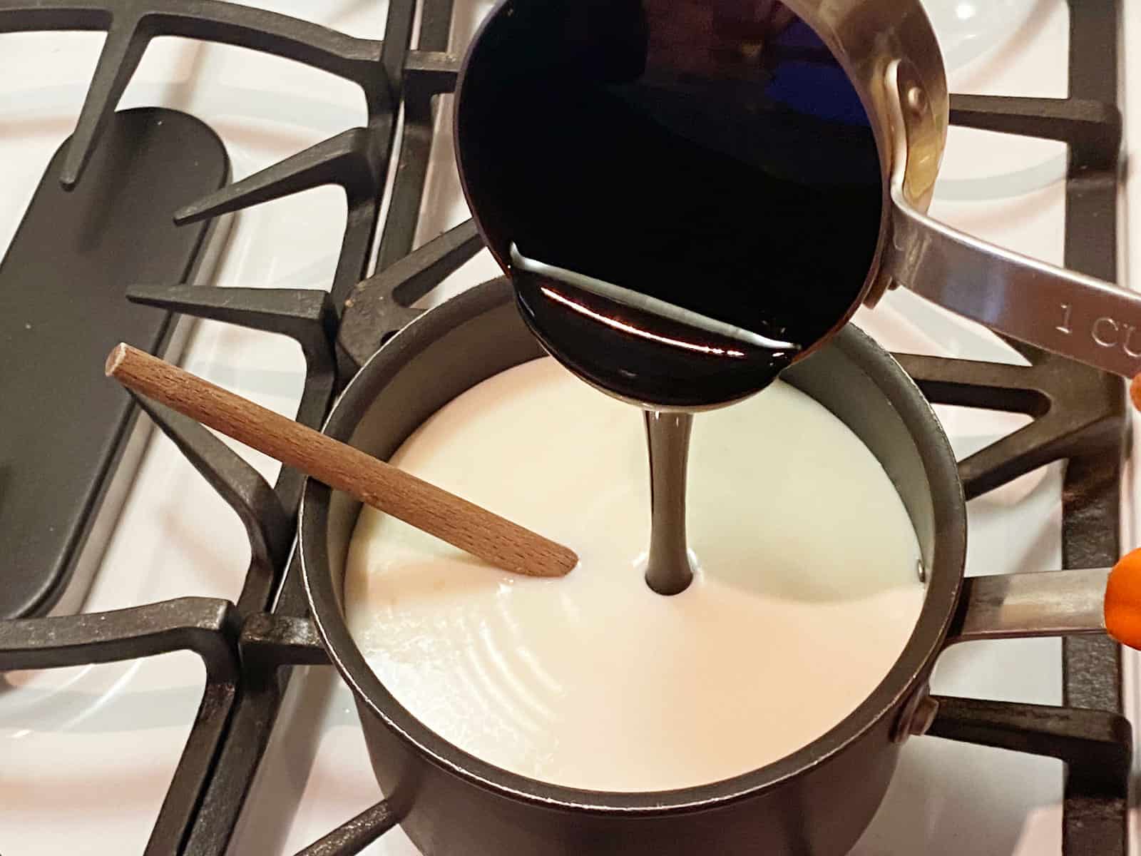 Molasses being poured into milk and cream