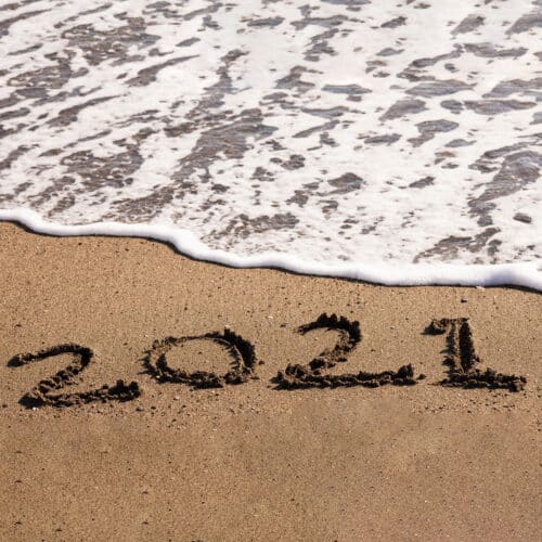 2021 in sand being washed away by waves