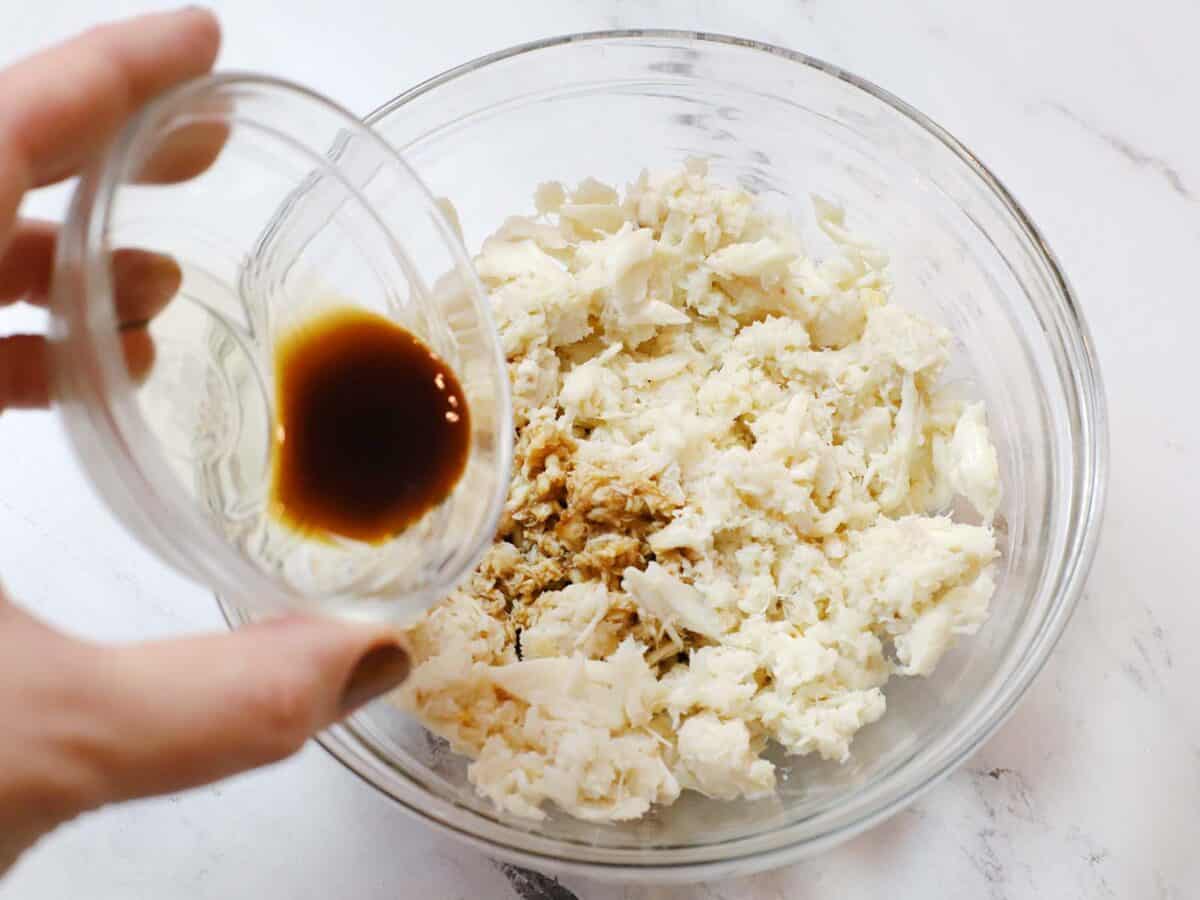 Pouring soy sauce into the crab meat mixture