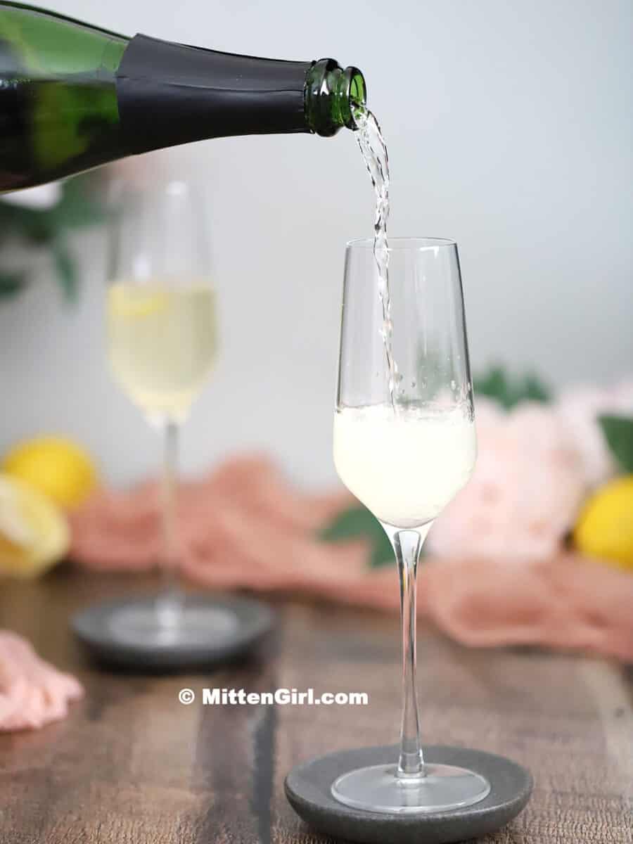 Prosecco pouring into a champagne glass.