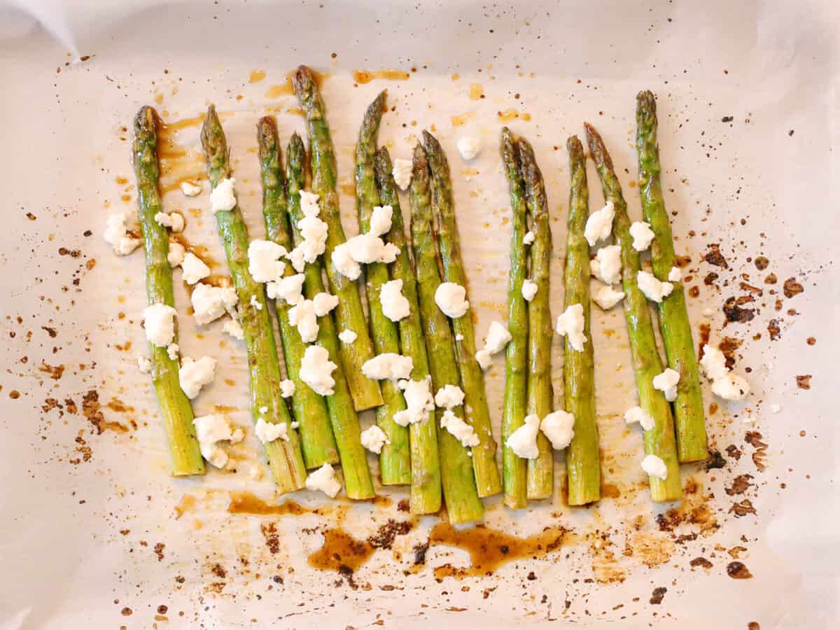 Goat cheese and balsamic vinegar on roasted asparagus.