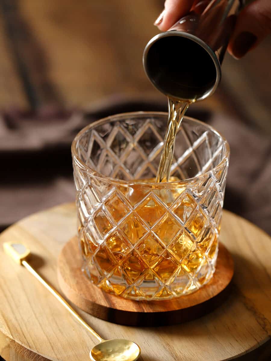 Whiskey being poured into a glass.