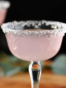 A glass filled with lavender lemon drop martini.