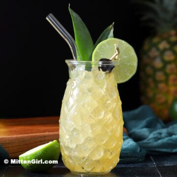 A Pineapple Mai Tai in a pineapple shaped glass.