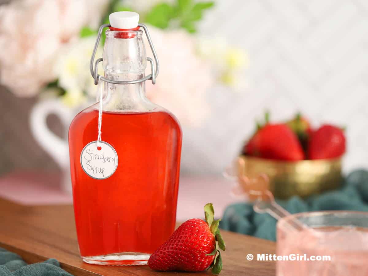 Strawberry Simple Syrup in a glass bottle. 