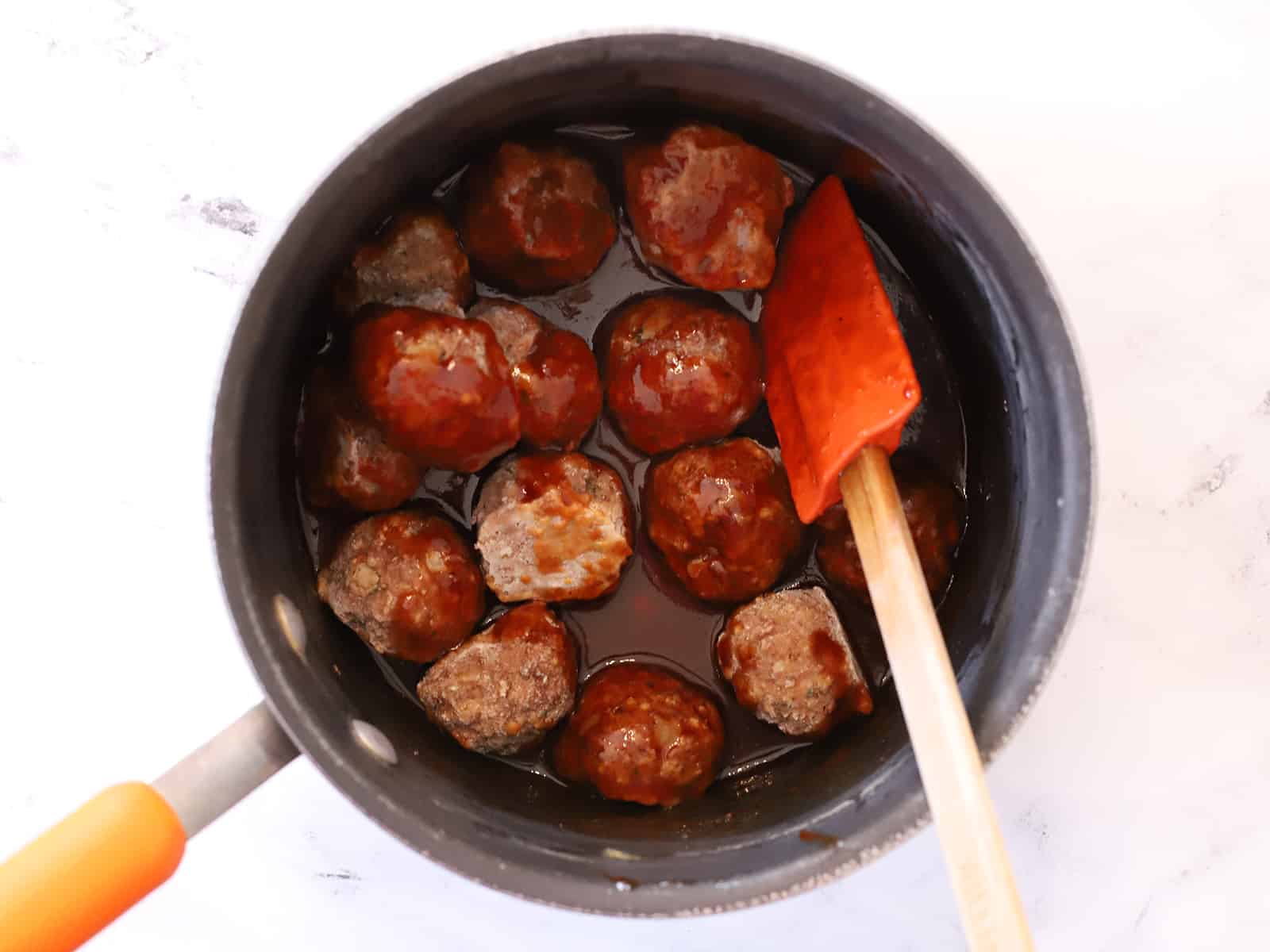 A pot full of meatballs and sauce. 