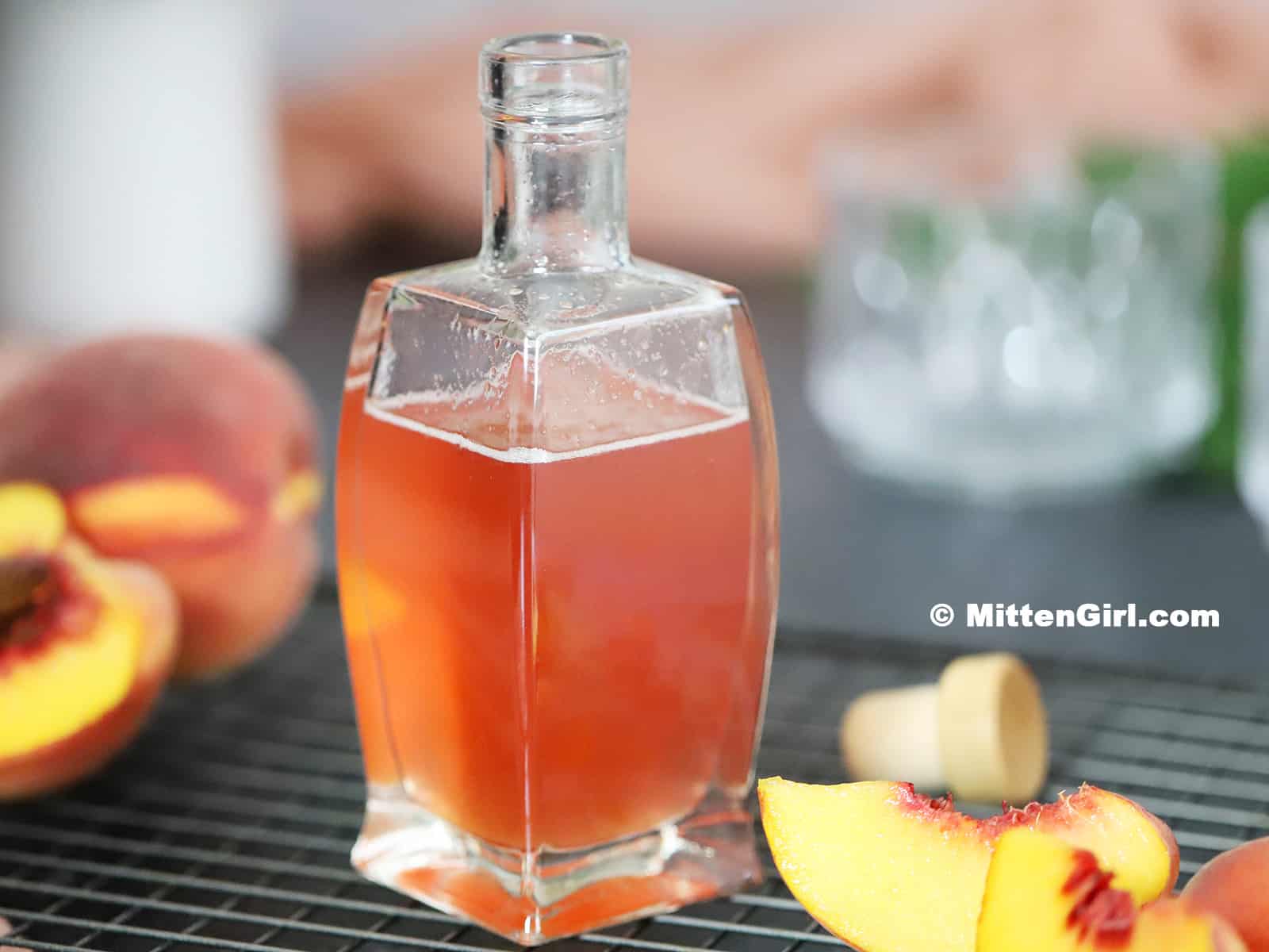 Homemade Peach Syrup in a bottle.