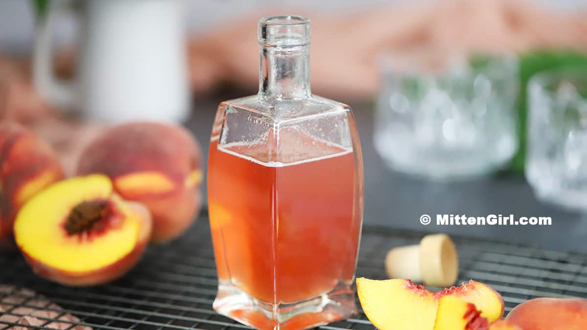 Homemade Peach Syrup in a bottle.