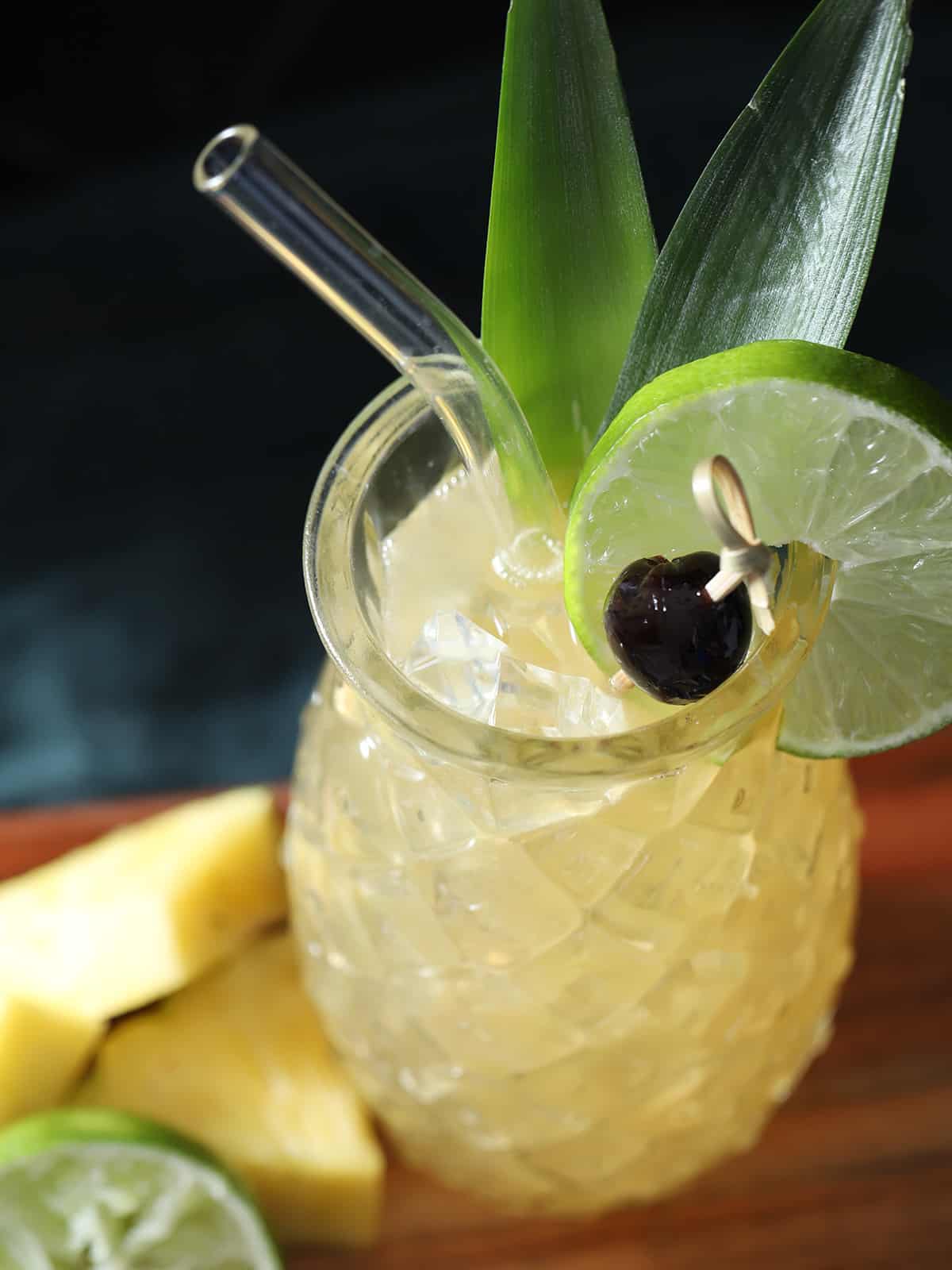 A glass full of pineapple mai tai. 