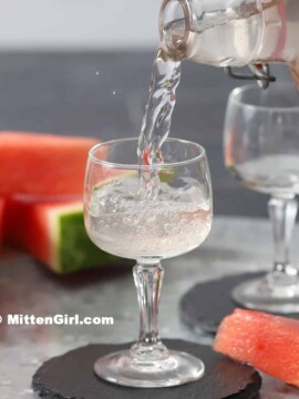 Watermelon Infused Vodka being poured into a small glass.
