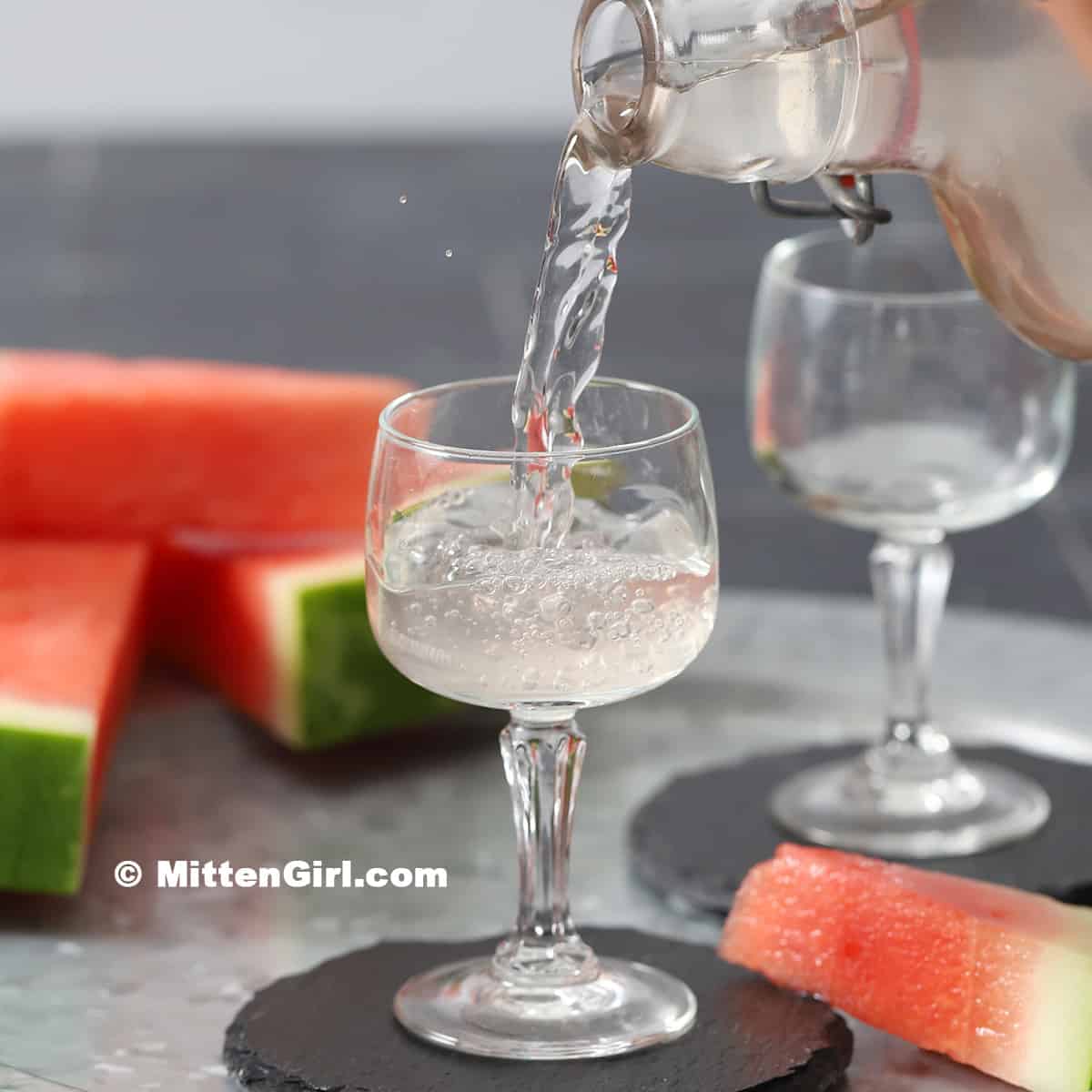 Watermelon Infused Vodka being poured into a small glass.