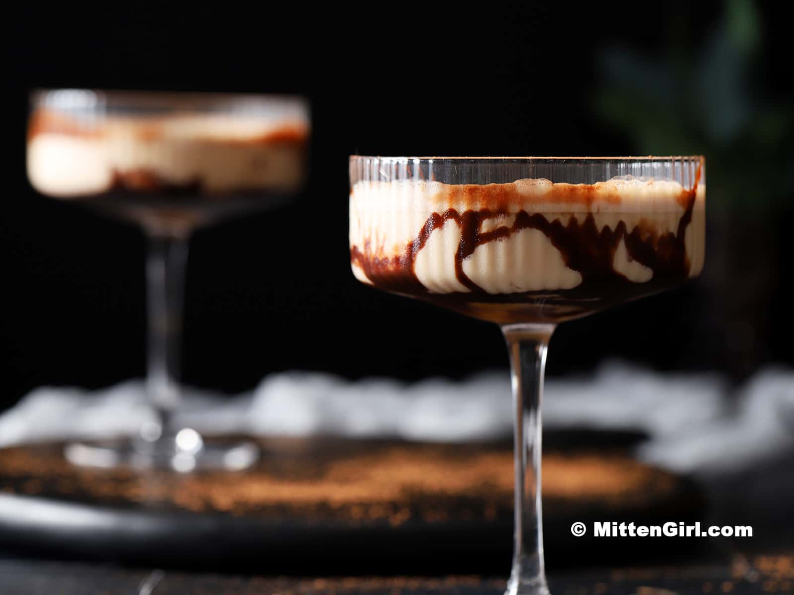 Glasses swirled with chocolate sauce and filled with chocolate caramel martini.
