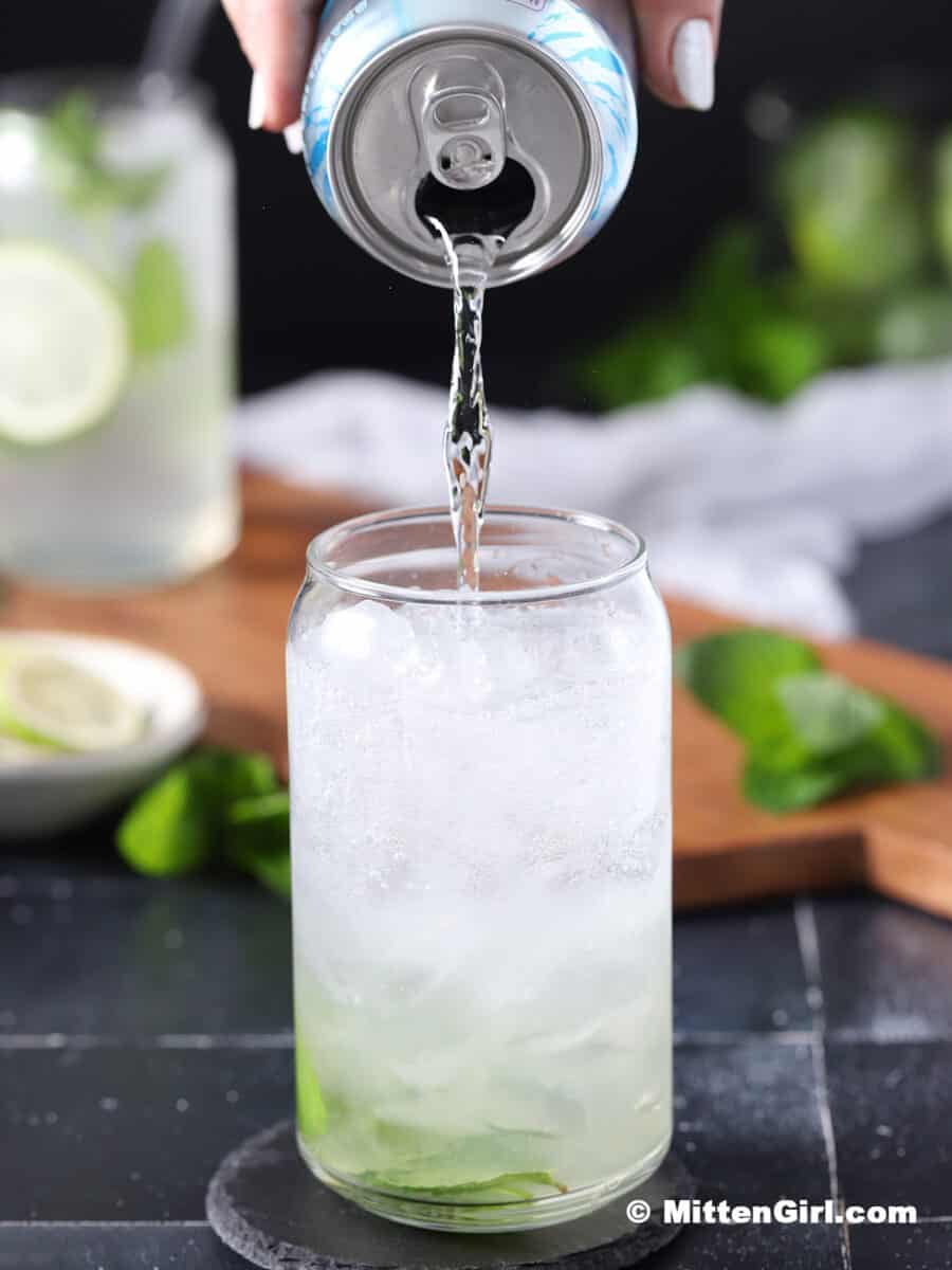 Club soda being poured into a glass.