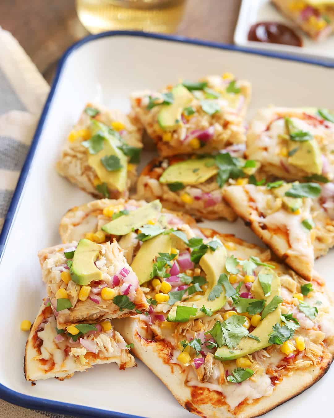 Slices of flatbread pizza on a platter.