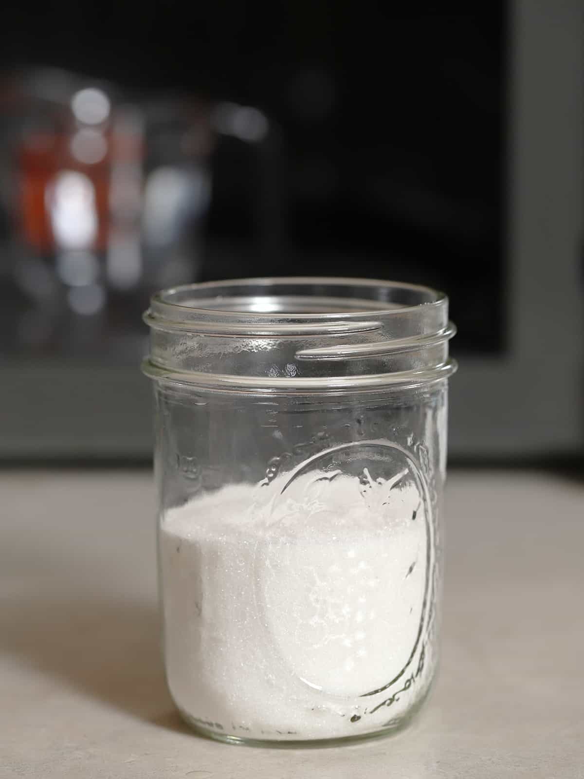 White sugar in a mason jar.