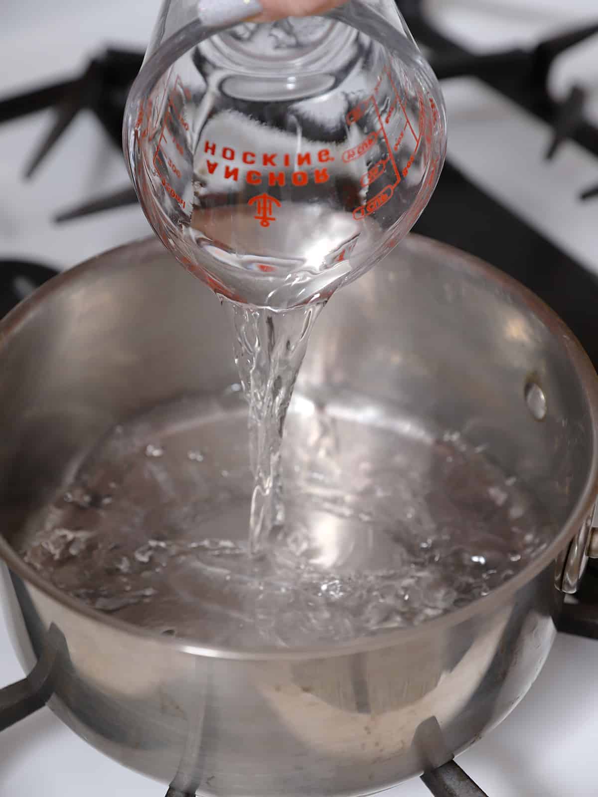 Water being poured into a pot. 