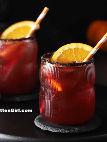 Two glasses filled with Halloween mocktails for kids.