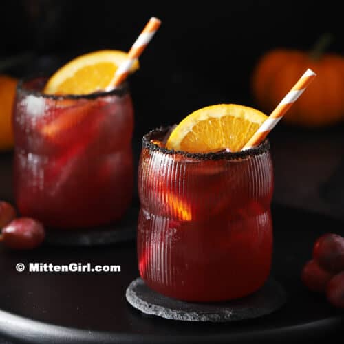 Two glasses filled with Halloween mocktails for kids.