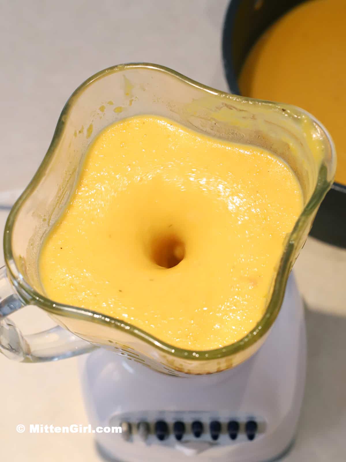 Soup being blended in a countertop blender.