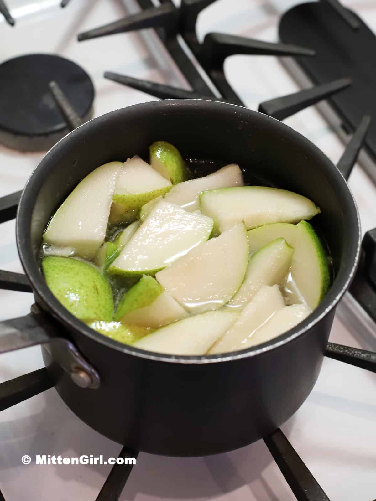 Pears, sugar, and water in a pot. 