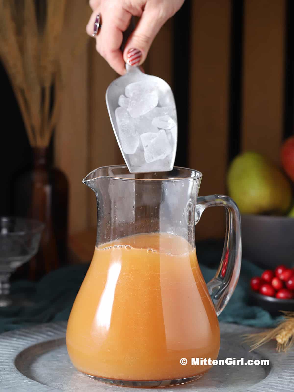 Ice being poured into a pitcher. 