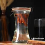A glass jar of cinnamon simple syrup.