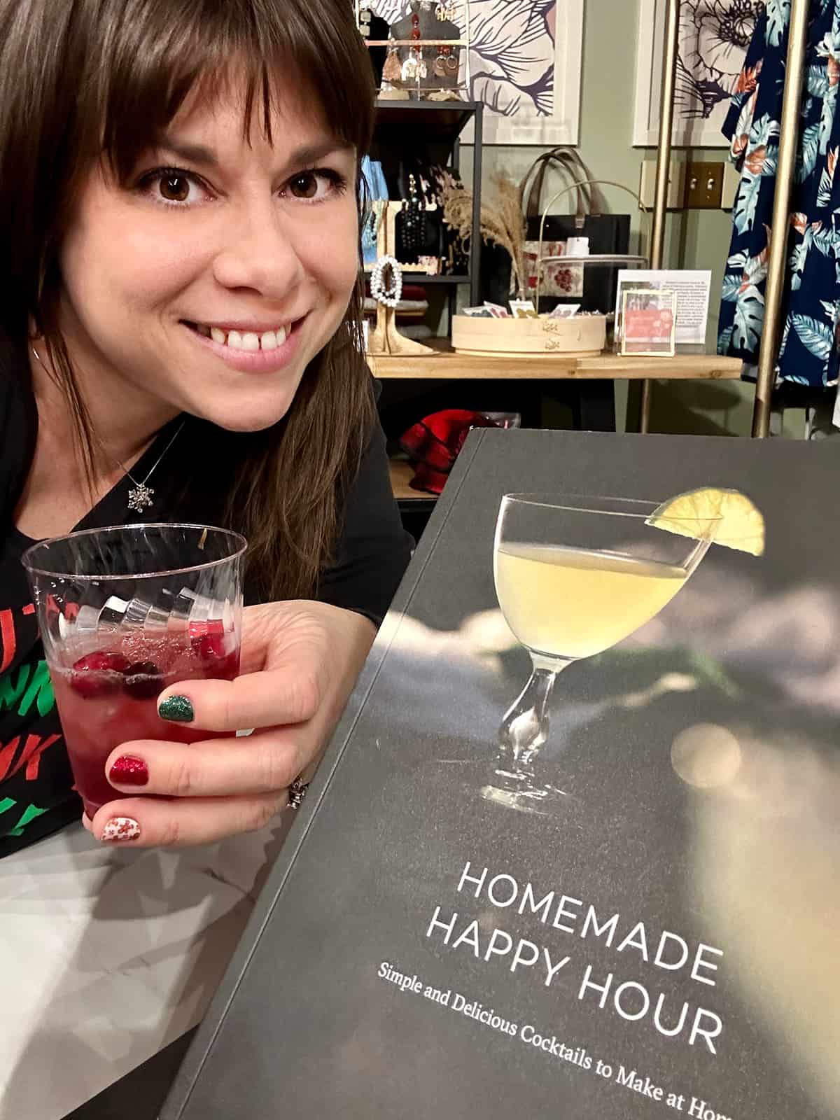 Katy with a cocktail at a holiday book signing.