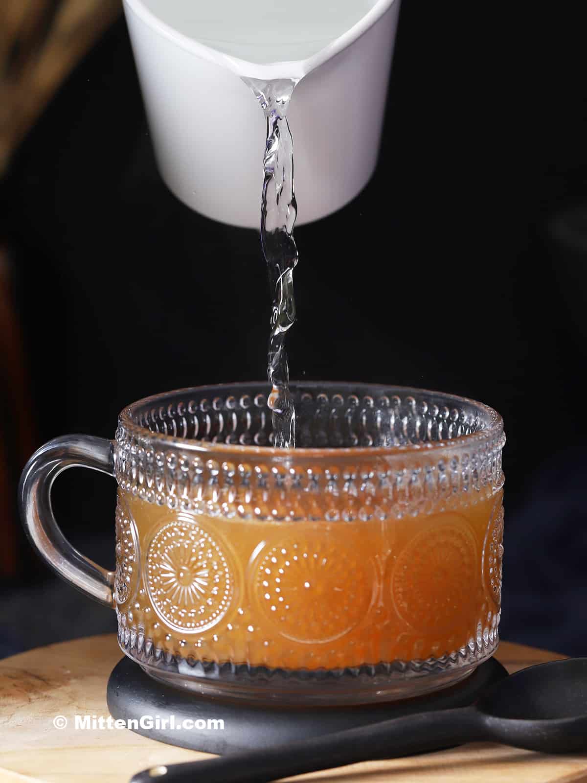 Hot water being poured into a mug.