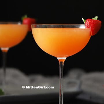 A glass of strawberry mocktail with pineapple.