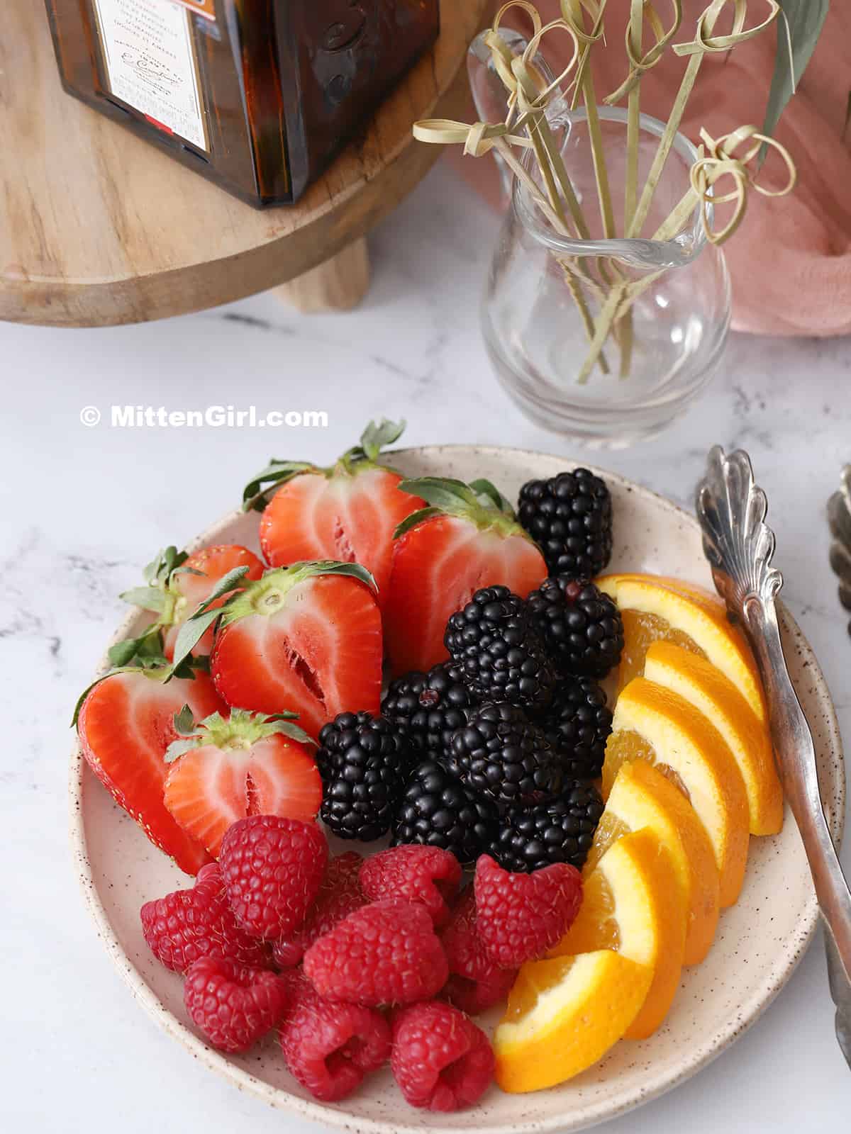 A plate of fruit, sliced up for garnish.