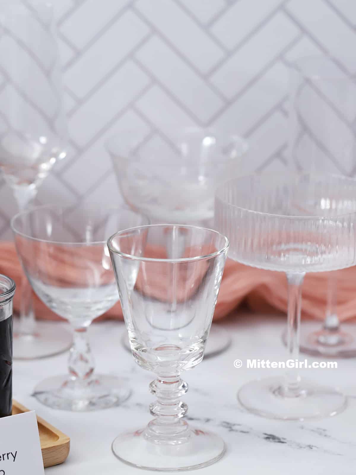 A selection of stemmed glassware set out on a mimosa bar. 