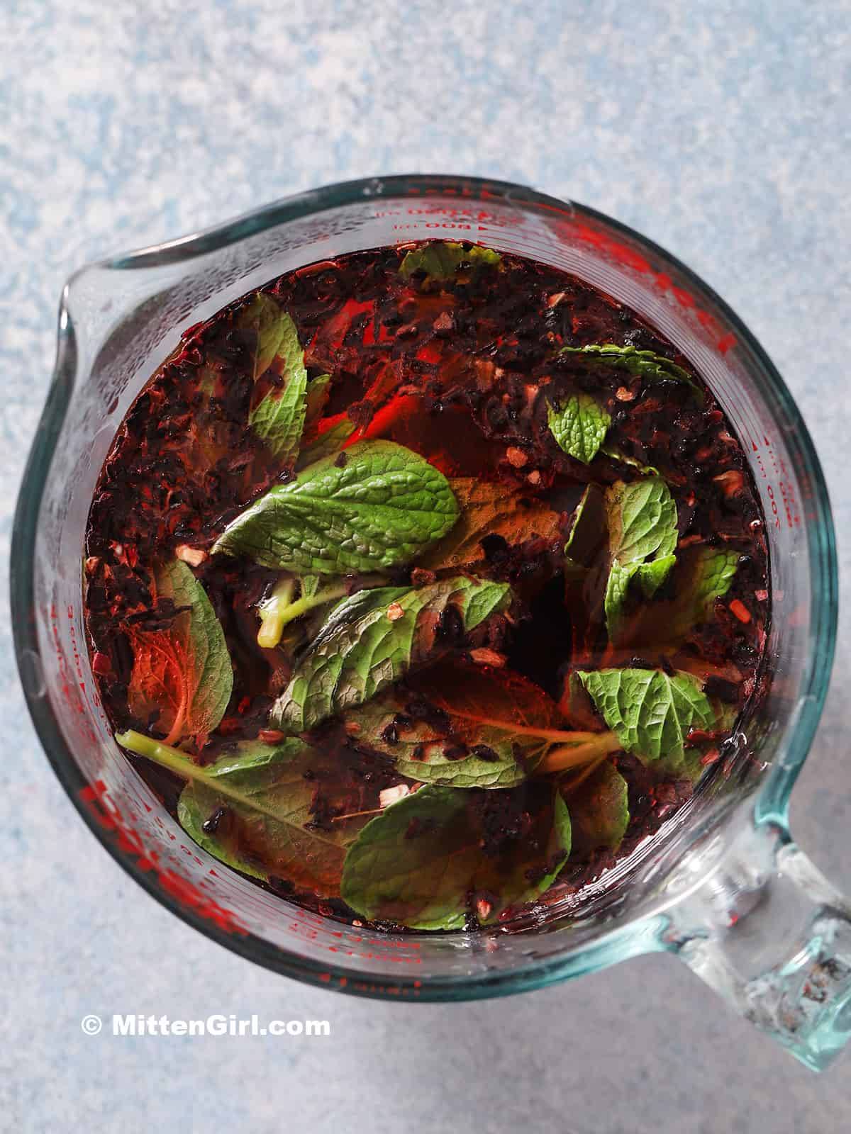 Fresh mint and dried hibiscus flowers in hot water. 