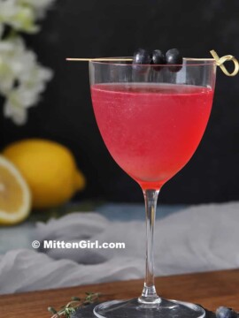 Glasses of blueberry lavender gin cocktails.