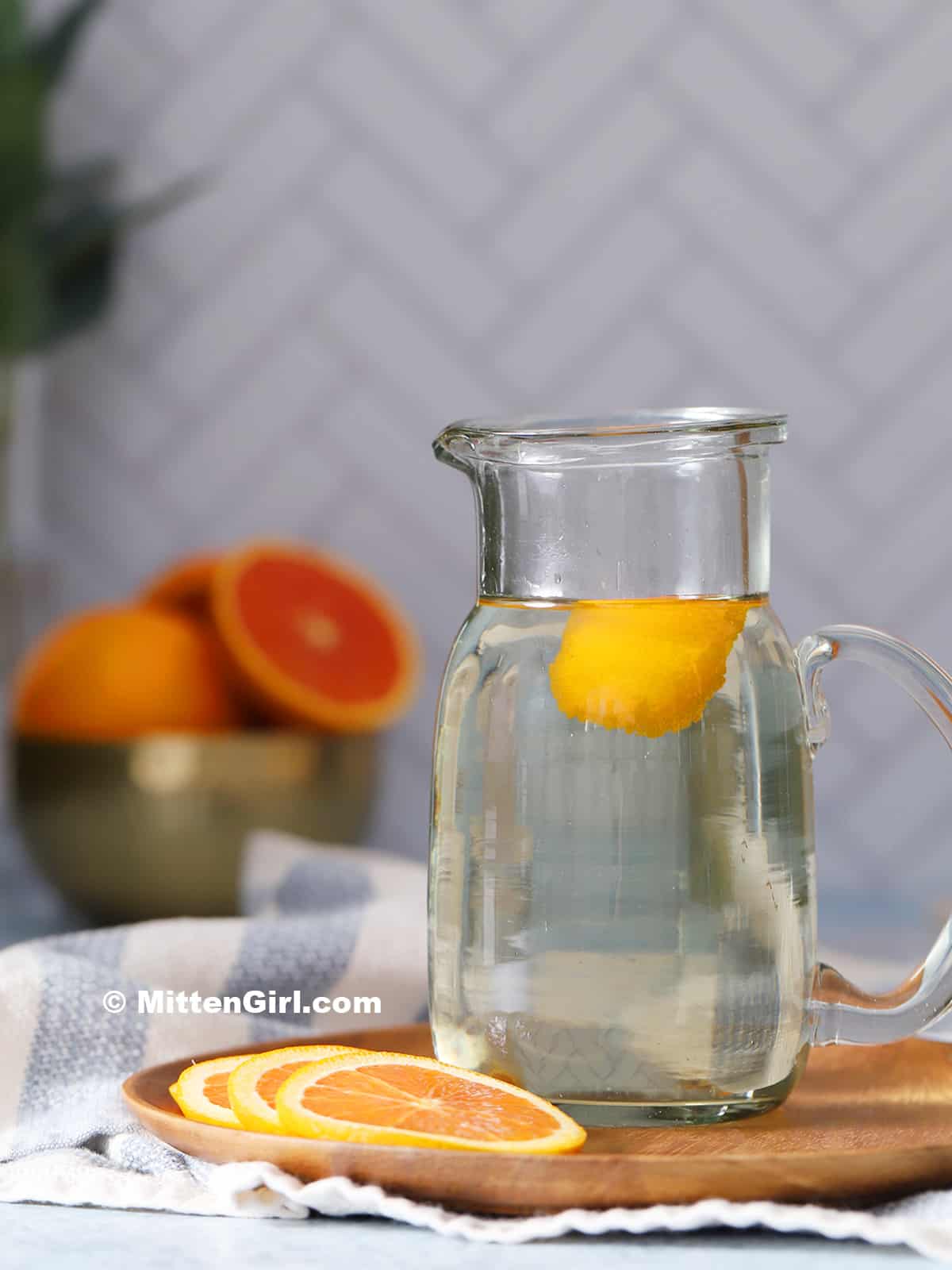 A glass bottle of orange syrup.